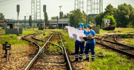 Pracownicy na tle torów